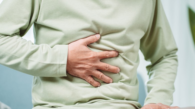 Person touching stomach constipated