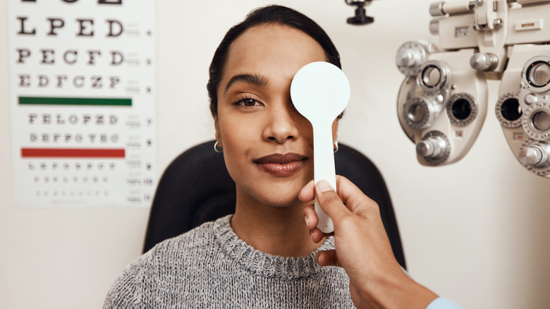 Smiling woman receiving eye exam