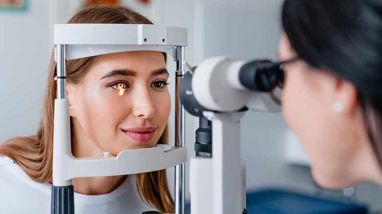 doctor performing eye exam on woman
