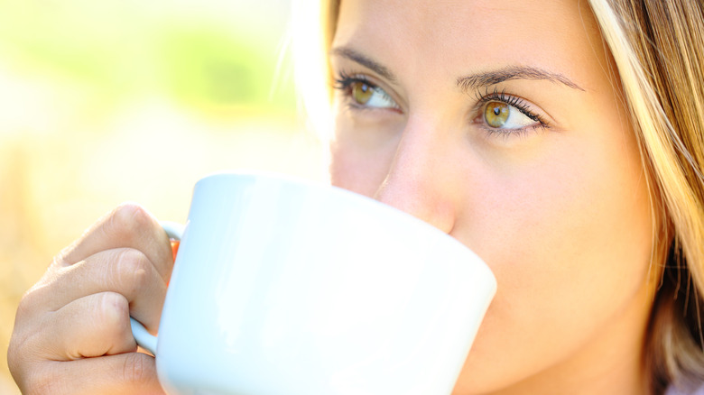 woman drinking from a mug
