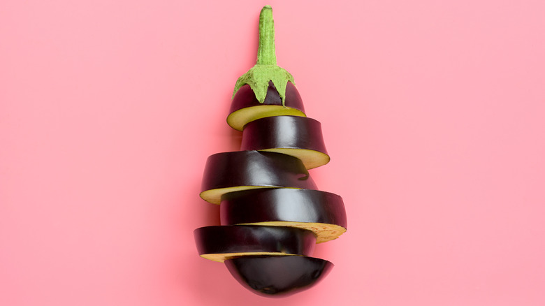 sliced eggplant on pink background 