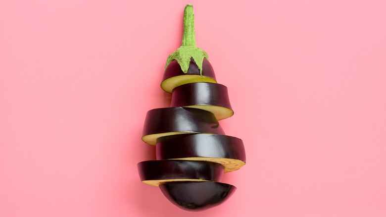 sliced eggplant on pink background