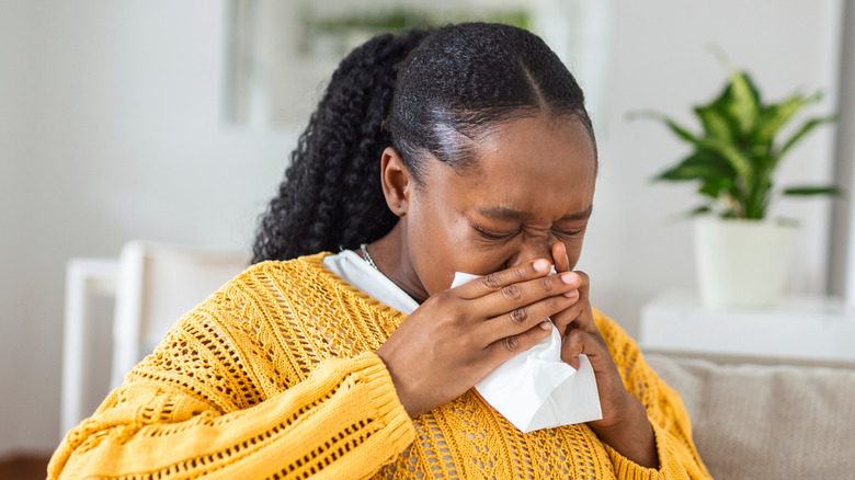 Woman blowing her nose