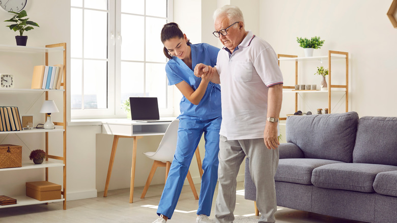 older man doing walking therapy