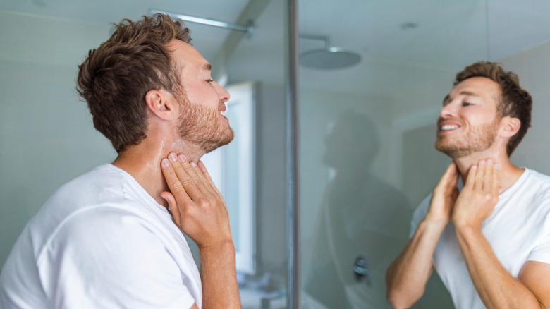 Adult putting on after shave