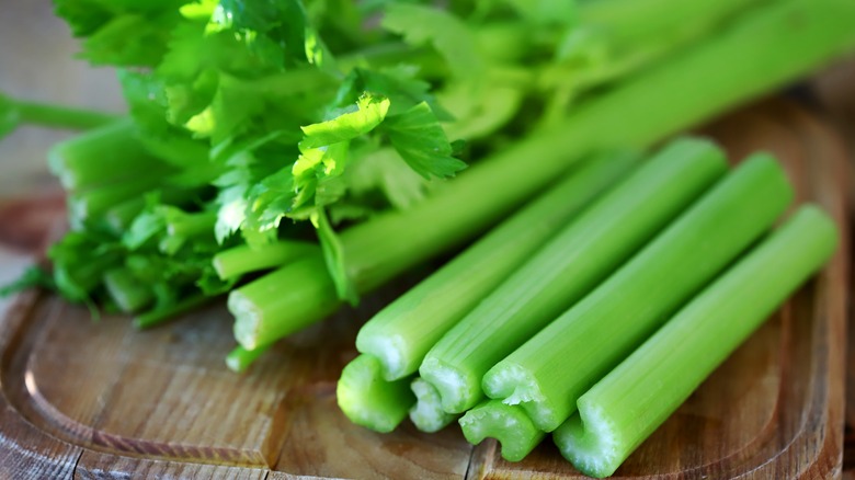 a woman holding a celery 