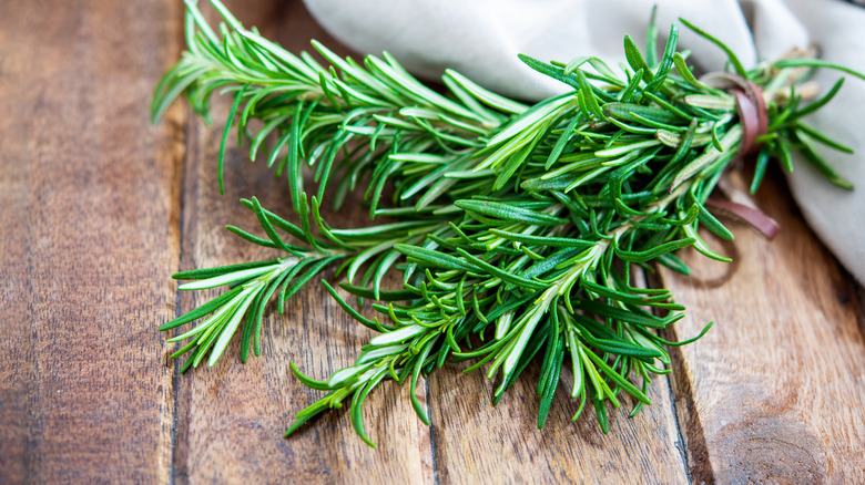 rosemary branch on a wood table 