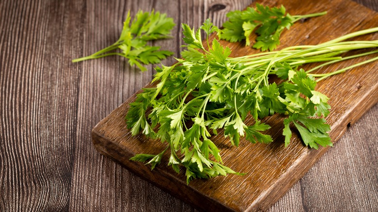 Parsley on wooden cutting board