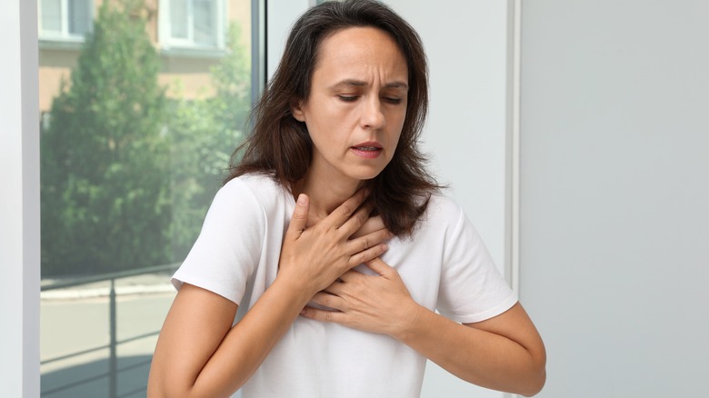 Woman struggling to breathe from anaphylaxis