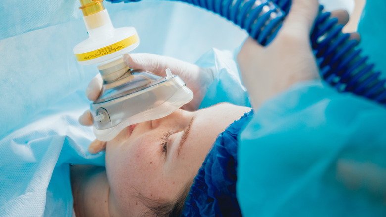 female patient in operating room going to sleep with mask anesthesia