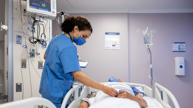 Nurse checking patient in ICU