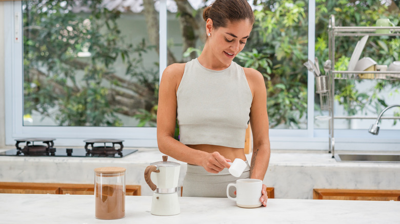 woman making protein coffee