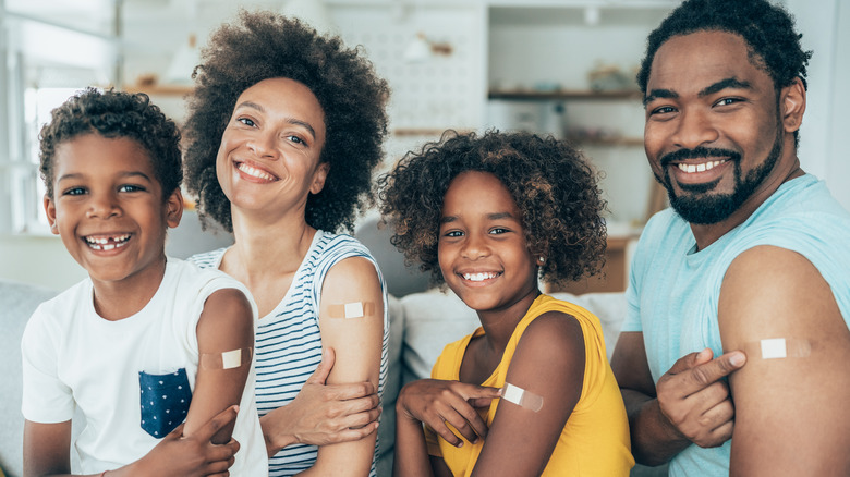 portrait of family showing bandage from flu shot