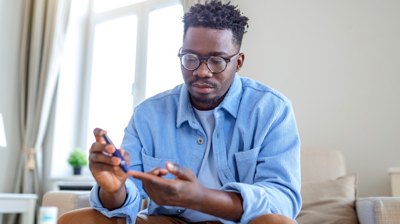 Afirican American man taking finger-prick test