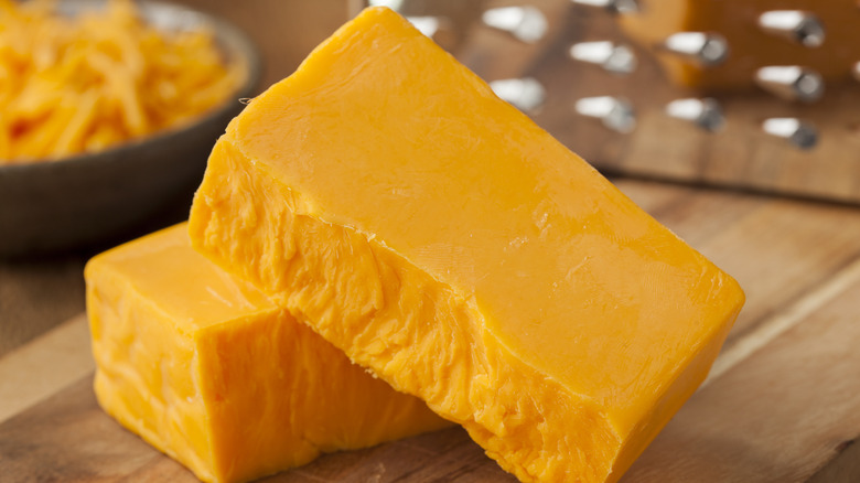 cubes of cheese on a cutting board