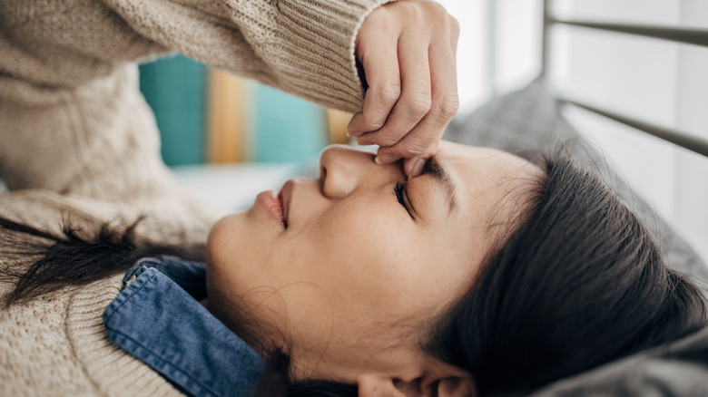 Woman lying down with headache