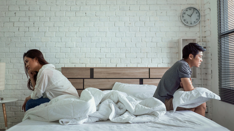 couple sitting on bed