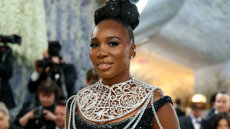 Venus Williams smiles for a photo at an upscale publicity event