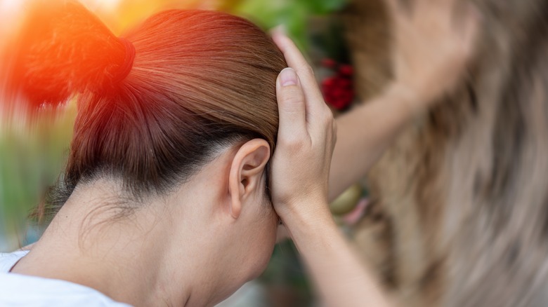 Woman with vertigo holding head