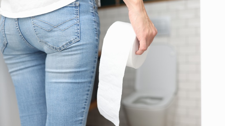 Woman holding toilet paper
