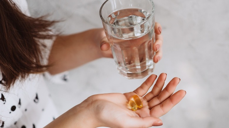 woman taking vitamin d supplement