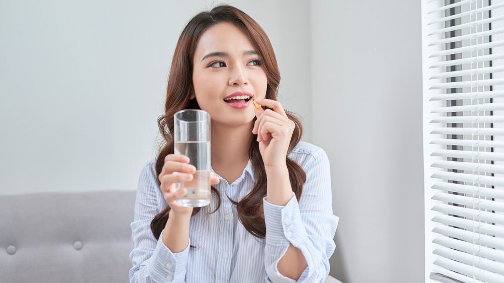 woman taking vitamins