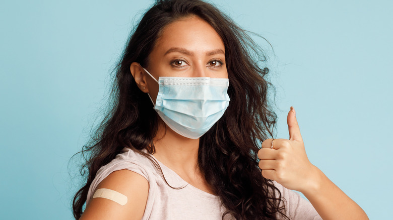 lady giving thumbs up after vaccination