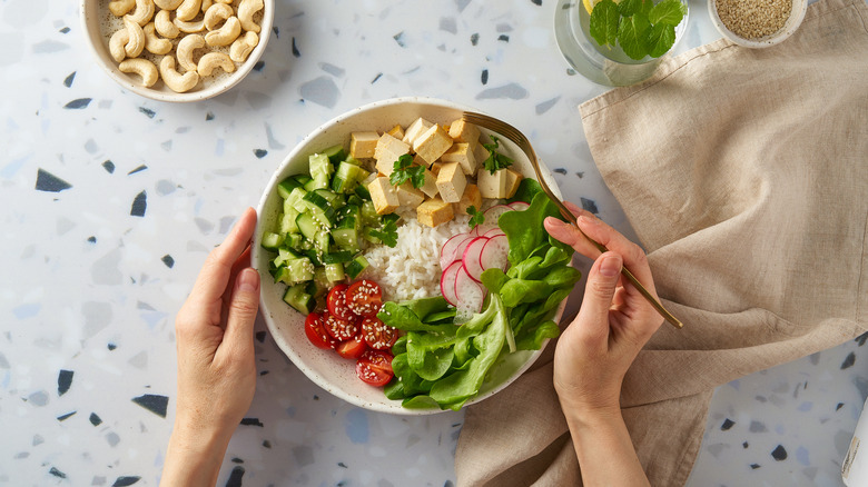 A bowl of vegetables, tofu, and rice
