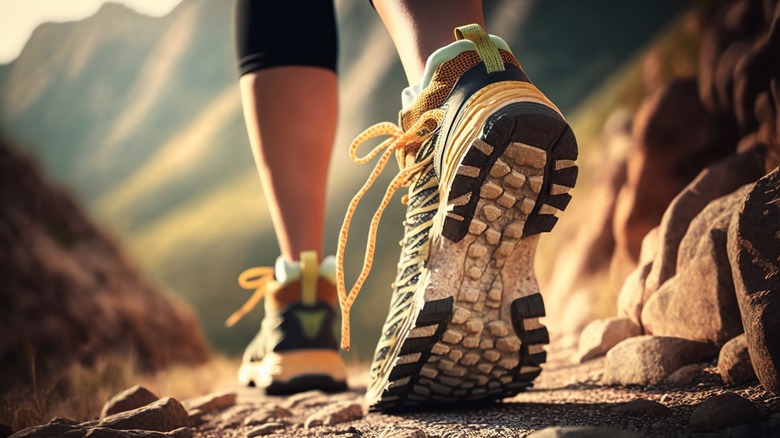close-up of woman's legs running on a trail