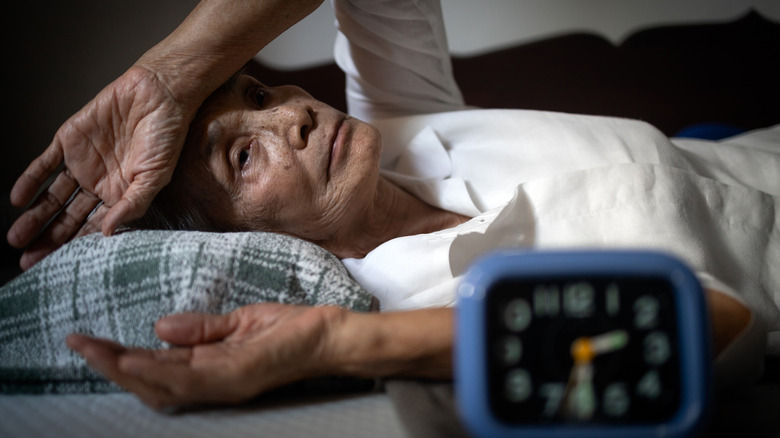 Older woman in bed having trouble sleeping