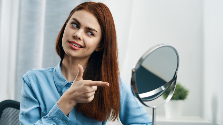 woman looking in mirror