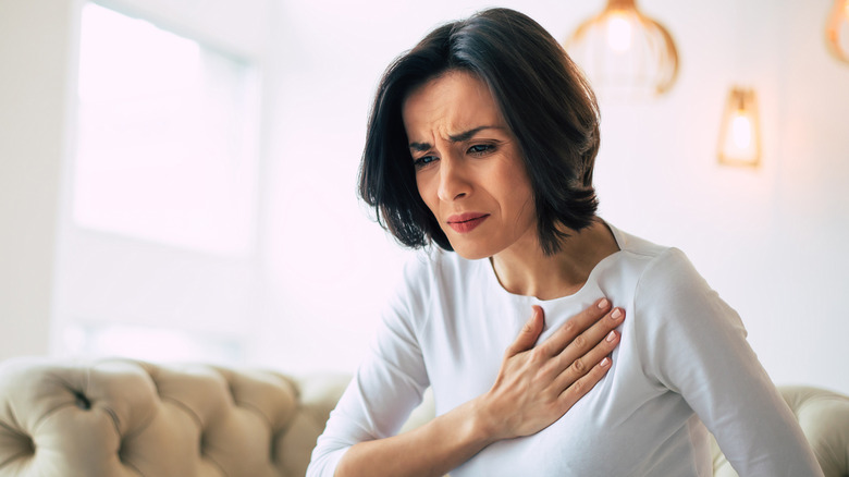 Woman holding her hand to her chest