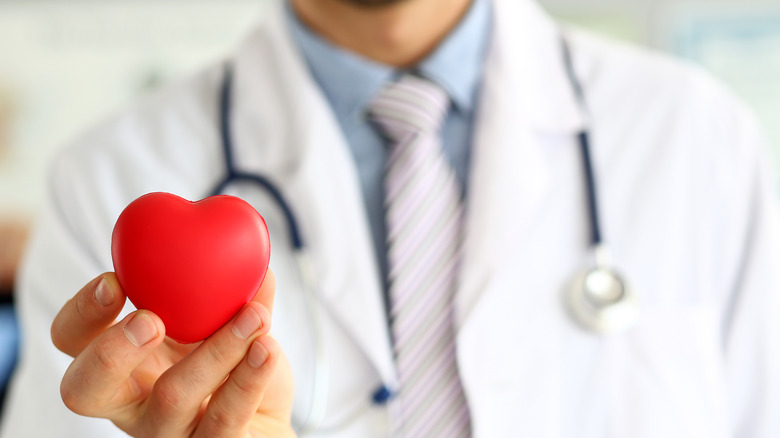 Doctor holding up a valentine heart 