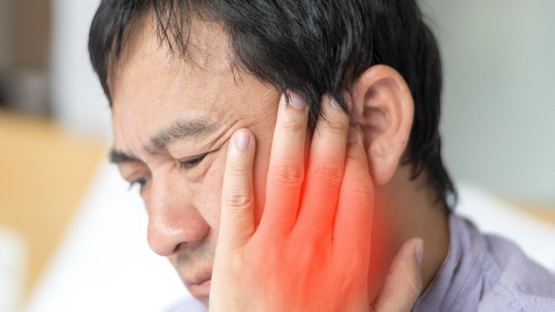 Man with jaw joint pain