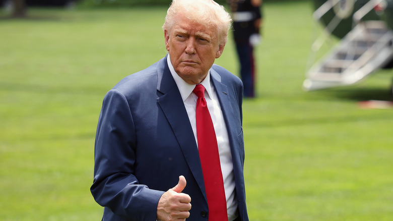Donald Trump walking and giving thumbs up