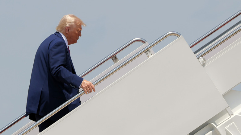 Trump climbing steps to Air Force One