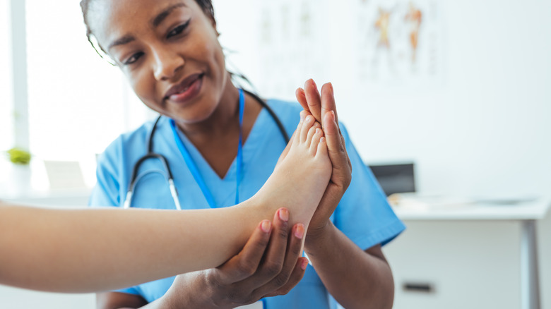 Doctor examining patient's foot
