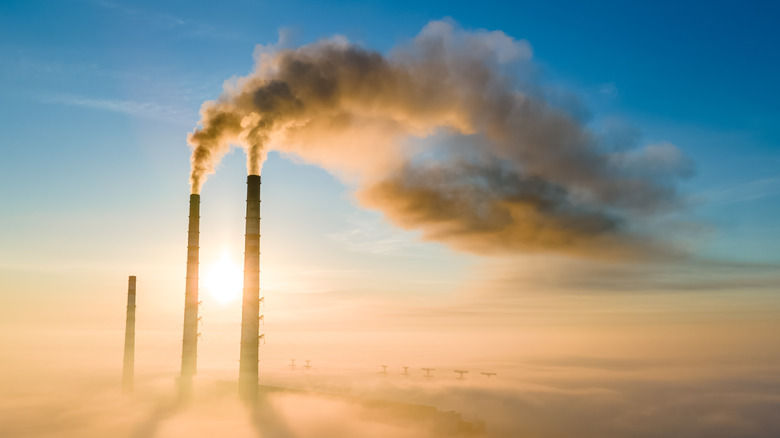 smokestacks blowing smoke into the sky