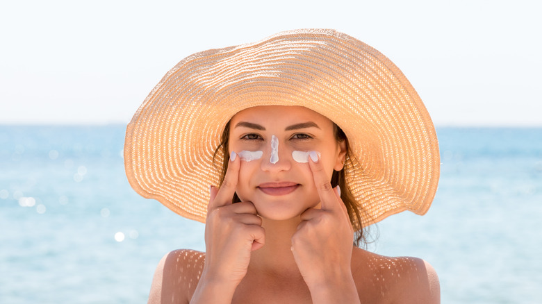 woman wearing hat and sunscreen