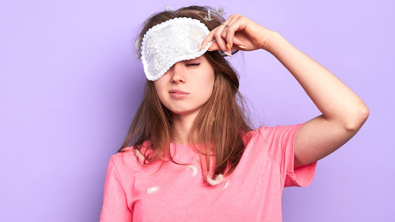 woman pulling up eyemask