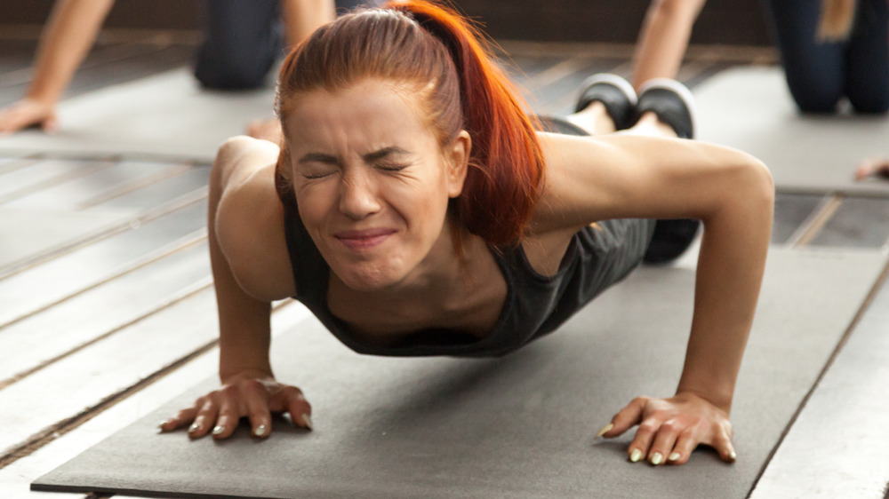 Woman struggling to do pushup
