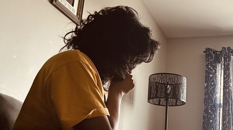 Woman coughing inside home