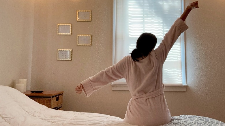 Woman waking up and stretching