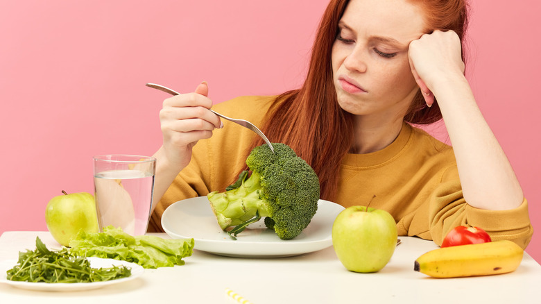 woman frowning over healthy foods