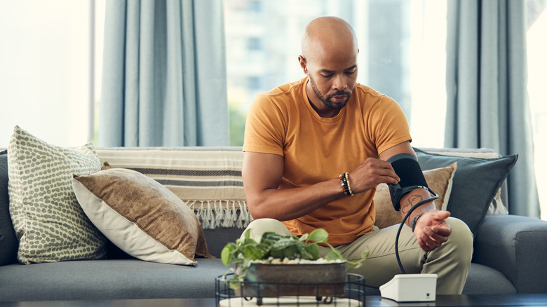 concerned man checking blood pressure