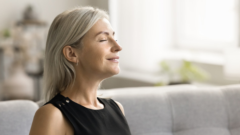 older woman smiling with her eyes closed