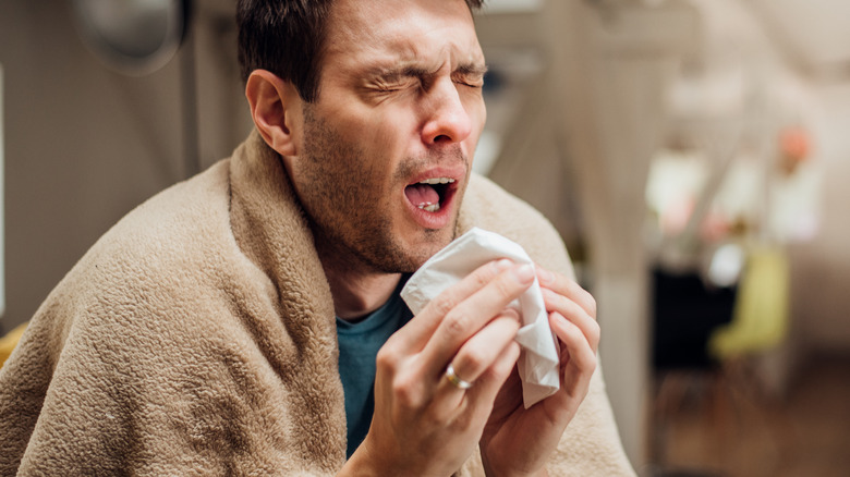 Man in the middle of a sneeze