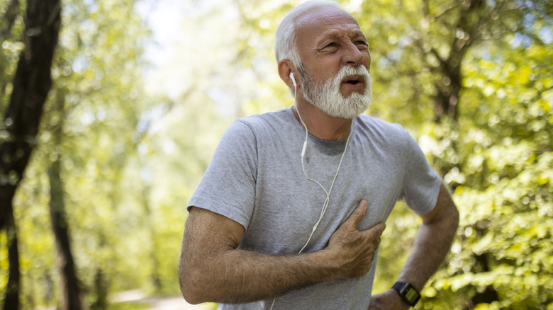 man suffering from a heart attack while on a walking trail