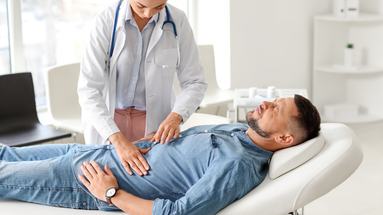 gastroenterologist examining a patient