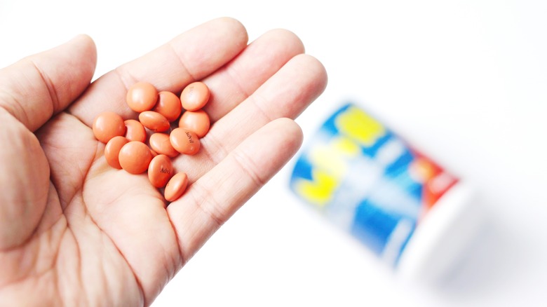 hand holding tablets of Advil